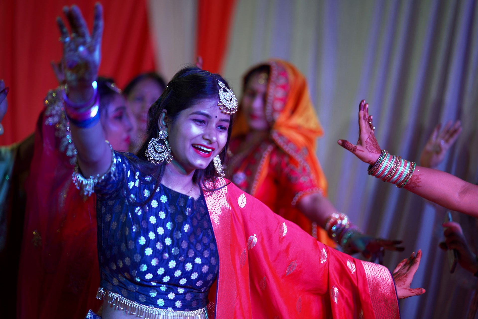 a woman in a blue and red outfit dancing